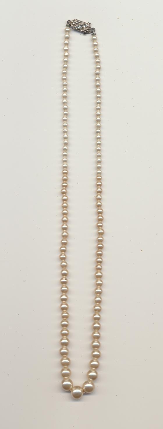 A missing bead in a necklace of faux pearls made of graduated pearl coated glass beads, ca.1950's, length 18'' 45cm.